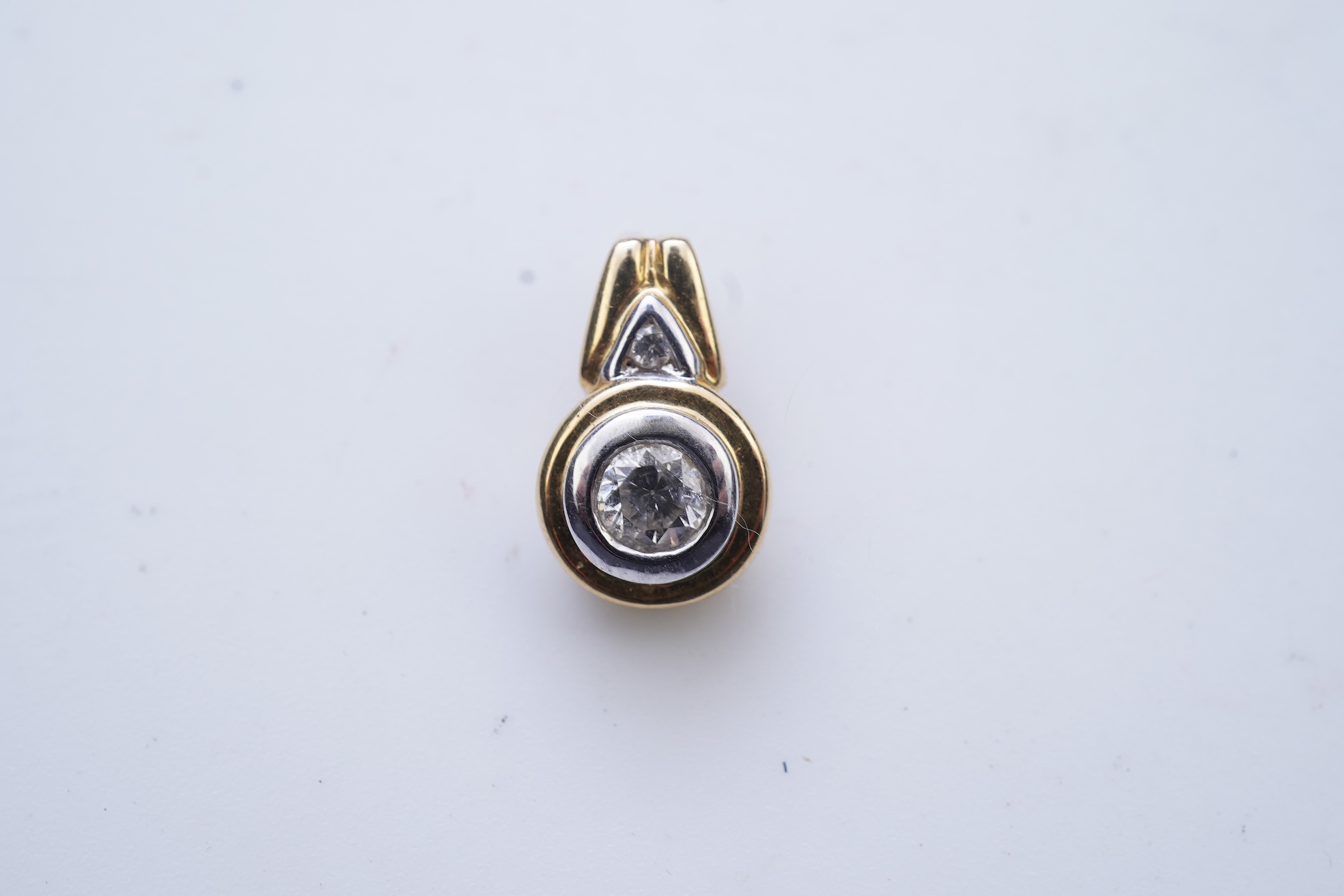 A diamond pendant and pair of diamond stud earrings